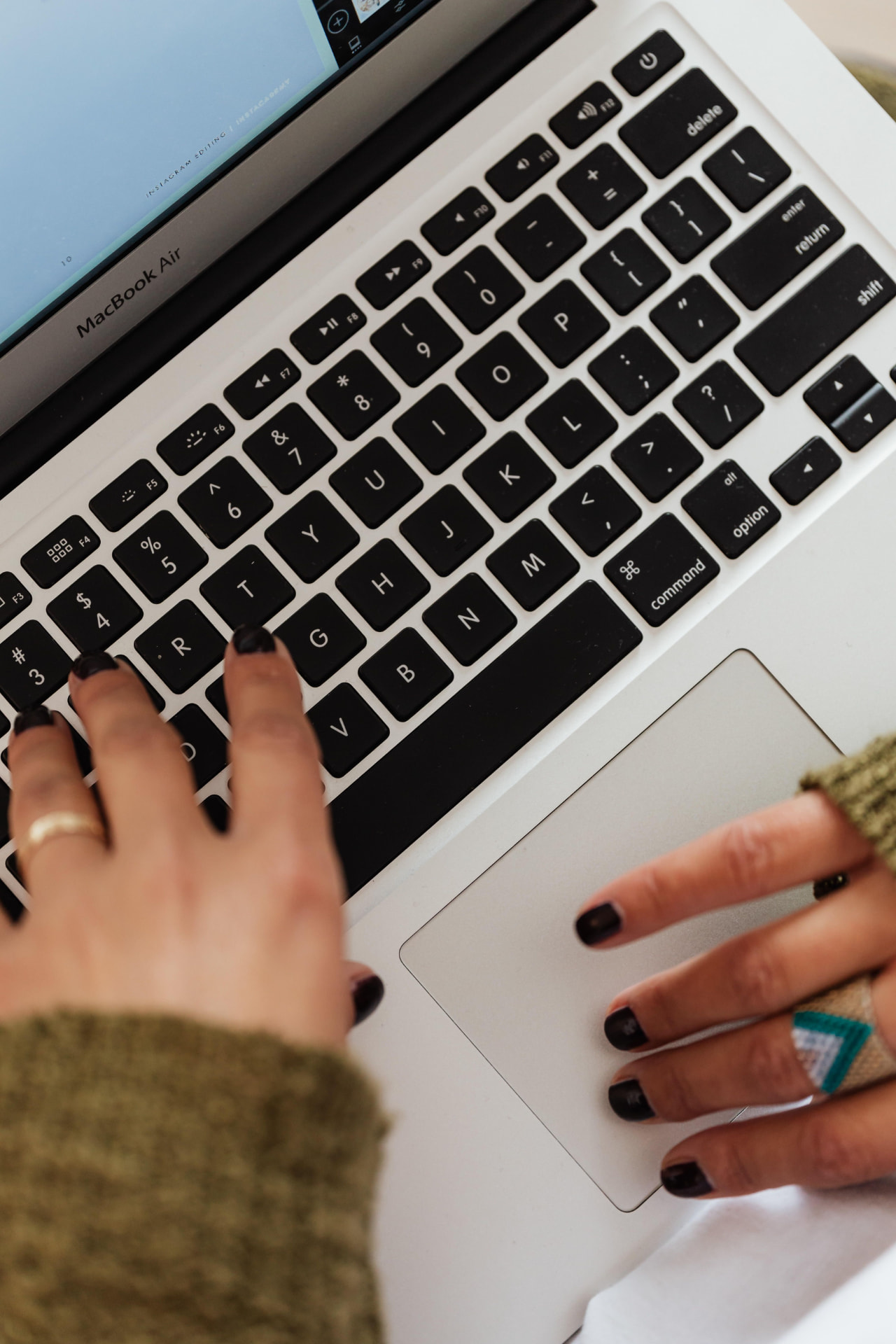 Overhead view of hands editing on a MacBook Air